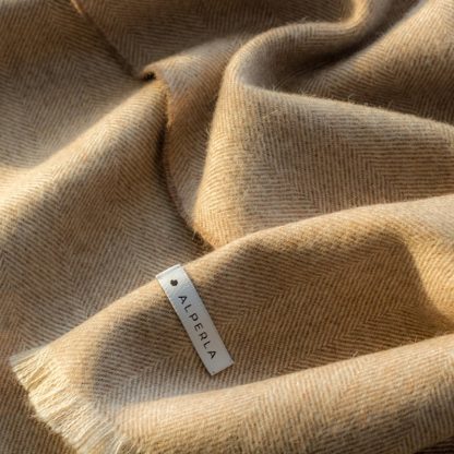 Beautiful beige alpaca blanket in golden sunshine