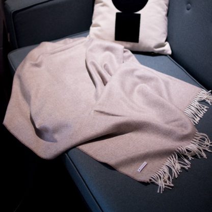 Beige alpaca blanket in warm lighting