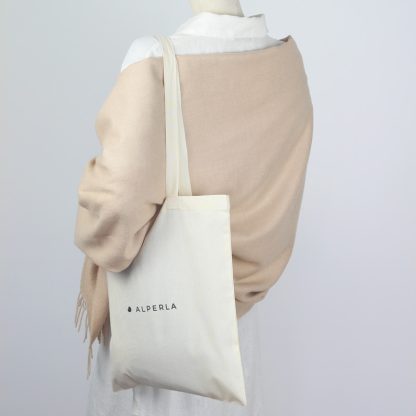 Beige woollen blanket thrown over the shoulders