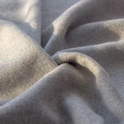 Grey alpaca throw with chevron pattern perfect for autumn evenings